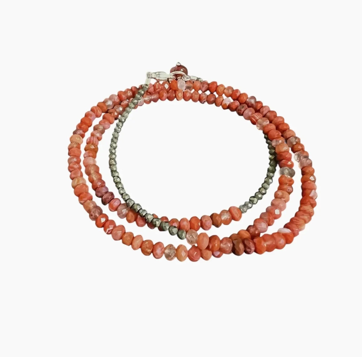 The ANN LIGHTFOOT Faceted Carnelian Triple Wrap Bracelet features irregular red-orange carnelian-inspired beads and small metallic gray accents, finished with a sterling silver clasp and shown on a white background.