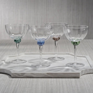 Introducing the MARTINI COCKTAIL OPTIC GLASS set by ZODAX: a collection of four elegant cocktail glasses featuring clear bowls with colorful accents. Each glass boasts a wide bowl and a slender stem, with bases in distinct colors—green, blue, gray, and light pink—perfect for showcasing the dimensions and capacity of your cocktails in style.