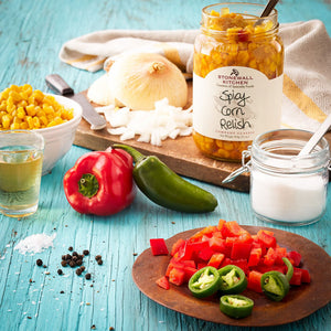 A 17 oz (482 grams) jar of STONEWALL KITCHEN - SPICY CORN RELISH features a Tex-Mex themed label with the product name and "gluten free" description. The jar showcases yellow corn relish with visible corn kernels and spices, topped with a silver lid.