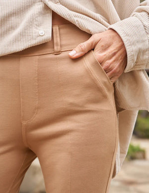 The FRANK & EILEEN - MURPHY BILLION DOLLAR PANT is showcased against a white background. These beige trousers feature a mid-rise fit, belt loops, front pockets, and a seam detail running down the center of each leg. The overall design is both simple and classic.