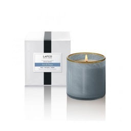 The LAFCO - SEA DUNE, BEACH HOUSE 6.5oz votive candle holder is displayed against a plain white background. Featuring a clear cylindrical design with a white inner surface, this sleek and minimalistic piece evokes the tranquil decor of a beach house, casting a subtle shadow to the right.