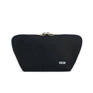 Presenting the KUSSHI - Signature Makeup Bag in Black: a stylish, zippered makeup bag with a rectangular shape and a slightly curved top. The pouch is adorned with two gold zipper pulls and features a small rectangular label with "KUSSHI" written in white letters on the bottom right corner. It offers spacious compartments and is conveniently machine washable for easy care.