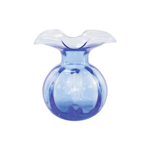 The VIETRI HIBISCUS BUD VASE COBALT is mouthblown with a translucent design, featuring a wide, flared wavy rim and bulbous base. Swirls of cobalt blue and purple elegantly blend throughout, creating an elegant and smooth appearance.