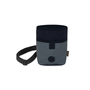 The PLAY PET LIFESTYLE TREAT POUCH ECLIPSE is a deluxe, two-toned cylindrical pouch featuring a drawstring opening at the top. The dark blue upper part contrasts with the gray lower section, enhanced by a black adjustable strap and a small circular black emblem near the bottom. It's perfect for holding dog training essentials or serving as a poop bag dispenser.