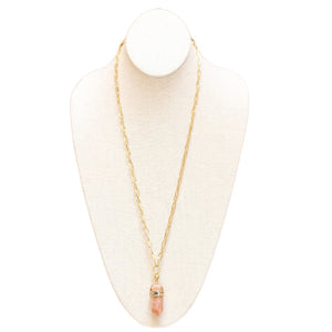 A mannequin bust displays a stunning GAS BIJOUX Aventura Pendant Necklace, featuring a rectangular pink gemstone pendant capped with metal and adorned with a small rock crystal stone. This elegant and minimalistic design beautifully emphasizes the gemstone.