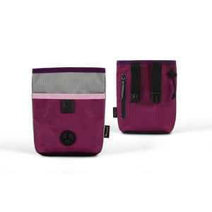 The small, rectangular TREAT POUCH WILDFLOWER from PLAY PET LIFESTYLE features a wrist strap and an elegant color block design with a plum purple lower section, a light pink middle strip, and a gray top. It is adorned with a black circular button on the front and includes a small tag on the side—making it the perfect pet accessory.