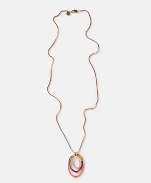 The DIP DYED NECKLACE by MOMONI is a long gold necklace featuring a delicate Venetian chain and interlocking oval pendants at the center. Made in Italy, the pendants showcase a layered look with gold, white, and coral colors. The necklace is displayed flat on a white background.